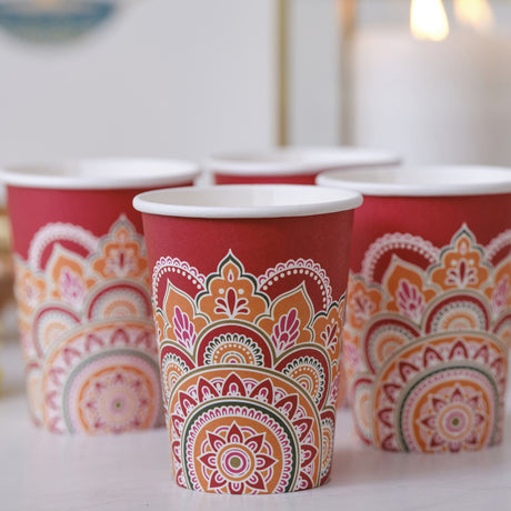 Vibrant red 9oz paper cups with intricate rangoli patterns, perfect for eco-friendly Diwali celebrations.