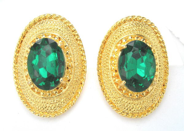 Gold earrings featuring a rhodium accent and a striking dark green stone, perfect for elevating any outfit's elegance.