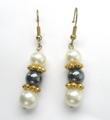 Lustrous freshwater pearls with gold hematine accents, perfect for elevating any outfit with elegance.