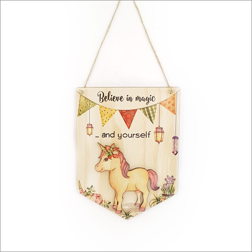 Printed pine flag featuring the phrase "Believe in Magic and Yourself," crafted from eco-friendly materials, ready to hang.