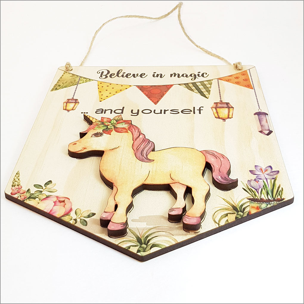 Printed pine flag wall art featuring the motivational message "Believe in Magic and Yourself," perfect for inspiring decor.
