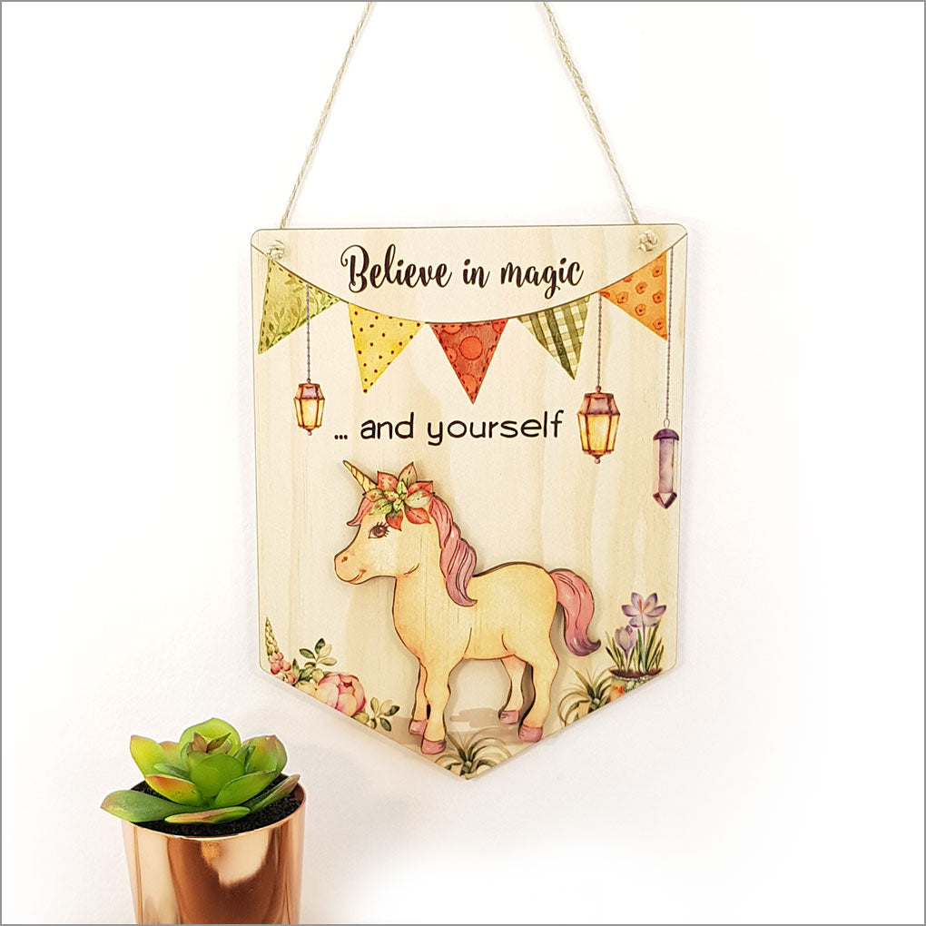 Printed pine flag wall art featuring "Believe in Magic and Yourself", crafted from eco-friendly materials, ready to hang.