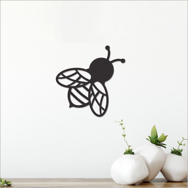 Wall art featuring a sleek black acrylic bee, measuring 11.5cm, adding elegance and whimsy to your decor.