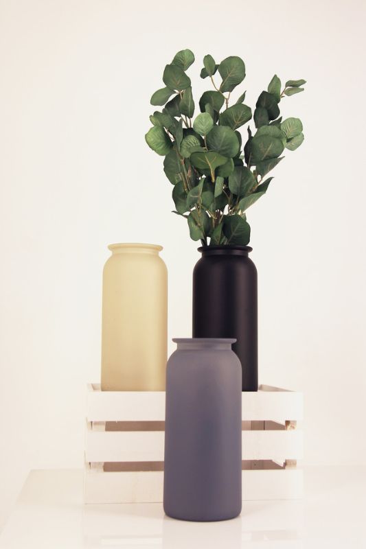 Set of 12 rustic glass apothecary vases with stone finish, perfect for elegant floral arrangements and home decor.