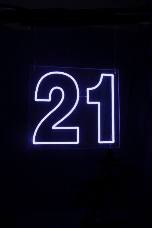 Neon LED '21' sign in white, bright wall decor for celebrations, includes 12V transformer and 3m cord, measures 650x570mm.