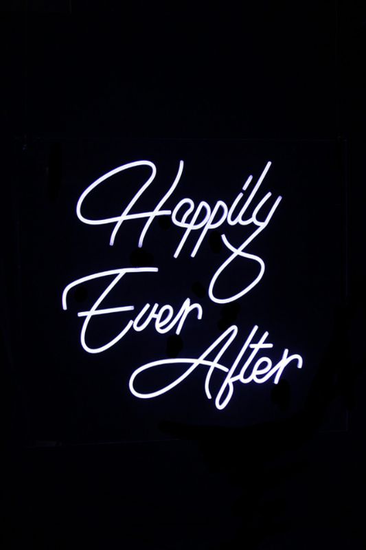 Neon LED sign reading 'Happily Ever After' in white, perfect for weddings and home decor, with soft ambient glow.