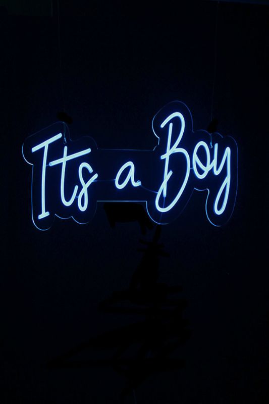 Neon LED sign reading "It's a Boy" in light blue, perfect for baby showers and nursery decor, beautifully wall-mounted.