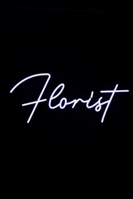 Neon LED sign reading 'FLORIST' in elegant white, designed for visibility and style in floral businesses.
