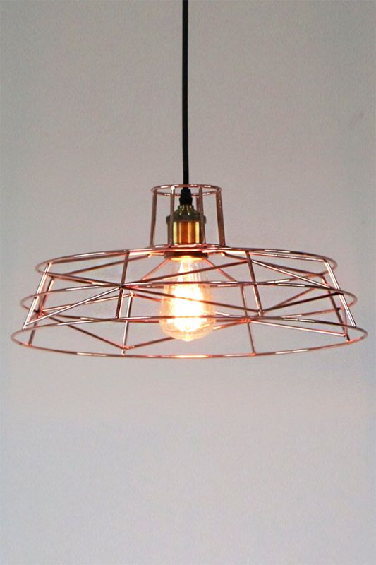 Elegant rose gold wire frame pendant light with geometric design, perfect for modern interiors and ambient illumination.