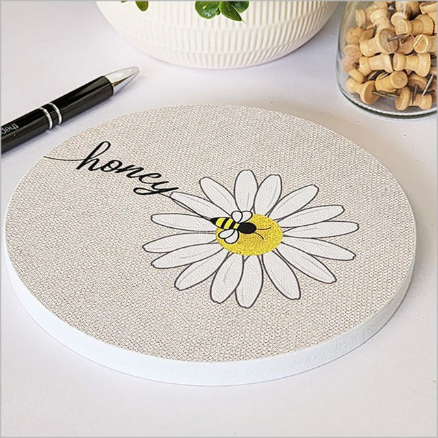 Canvas wall art featuring a honey bee on a vibrant daisy, 15cm circular design, perfect for home decor.