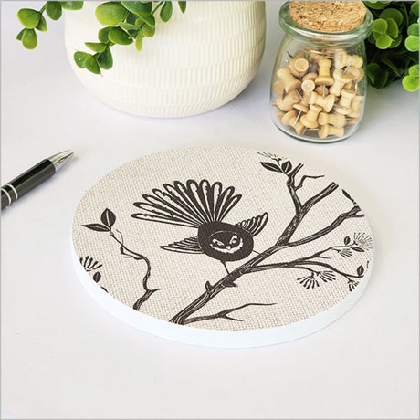 Round canvas art featuring a fantail on a pohutukawa tree, enhancing home decor with New Zealand's beauty.