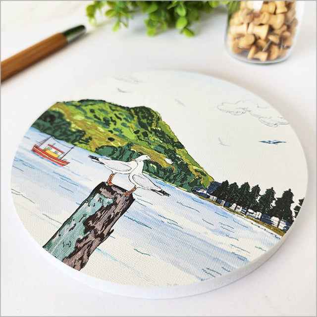 Circular canvas wall art featuring Mount Maunganui's serene landscapes, measuring 15cm, ready to hang for elegant decor.