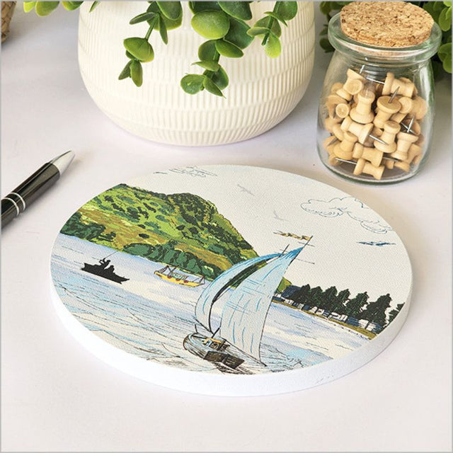 Canvas circle wall art featuring a vibrant print of Mount Maunganui, 15cm diameter, with an embossed finish for added texture.