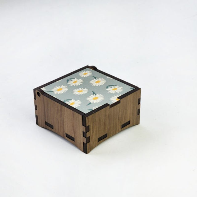 Square wooden trinket box made from reclaimed River Rimu, featuring a Mountain Daisy design, measuring 8cm.