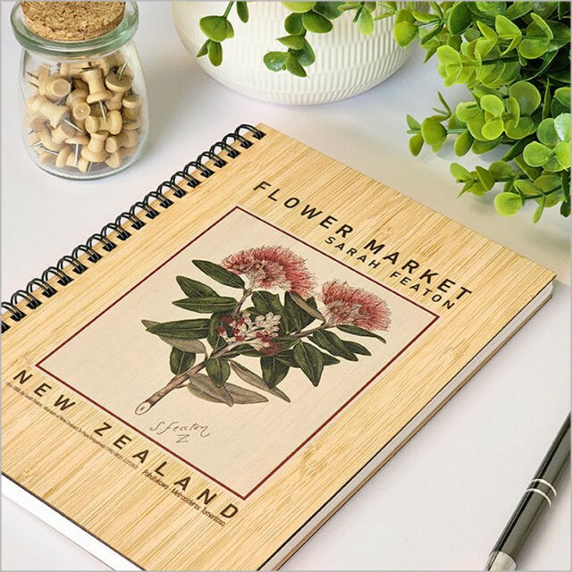 Bamboo Journal with laser-cut Pohutukawa design, 110 pages of eco-friendly 110gsm cartridge paper, perfect for creativity.