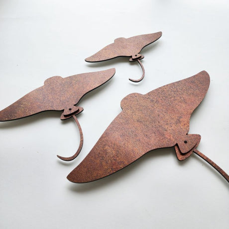 Wall art set featuring rusted copper stingray designs in three sizes, crafted from durable aluminium composite material.