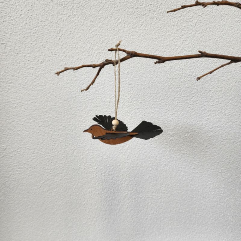 Elegant 11cm Rimu Tui ornament with laser-cut details and polypropylene wings, perfect for decor or gifts.