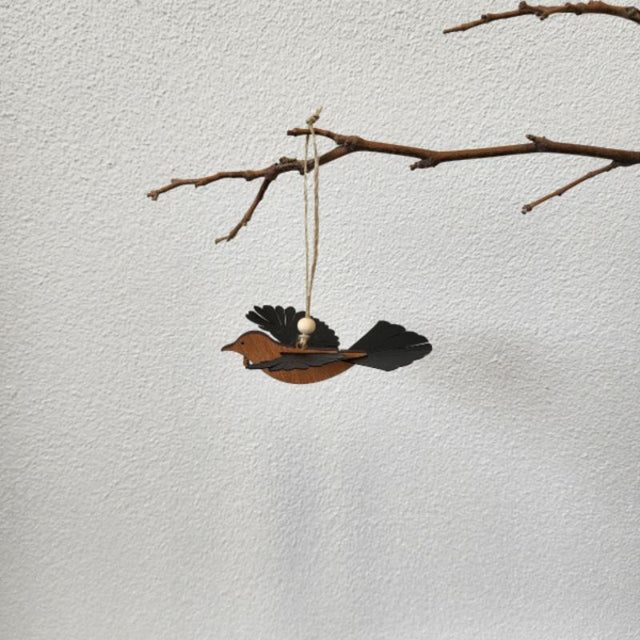 Elegant 11cm Rimu Tui ornament with laser-cut details and polypropylene wings, perfect for decor or gifts.