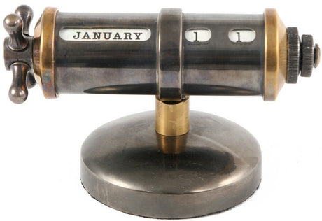 Sleek industrial-style table calendar in brass and nickel, featuring a convenient handle for easy date navigation.