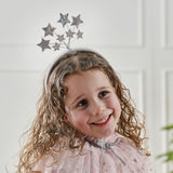 Whimsical pink satin headband adorned with 8 shimmering silver sequin stars, perfect for costumes and fairy parties.