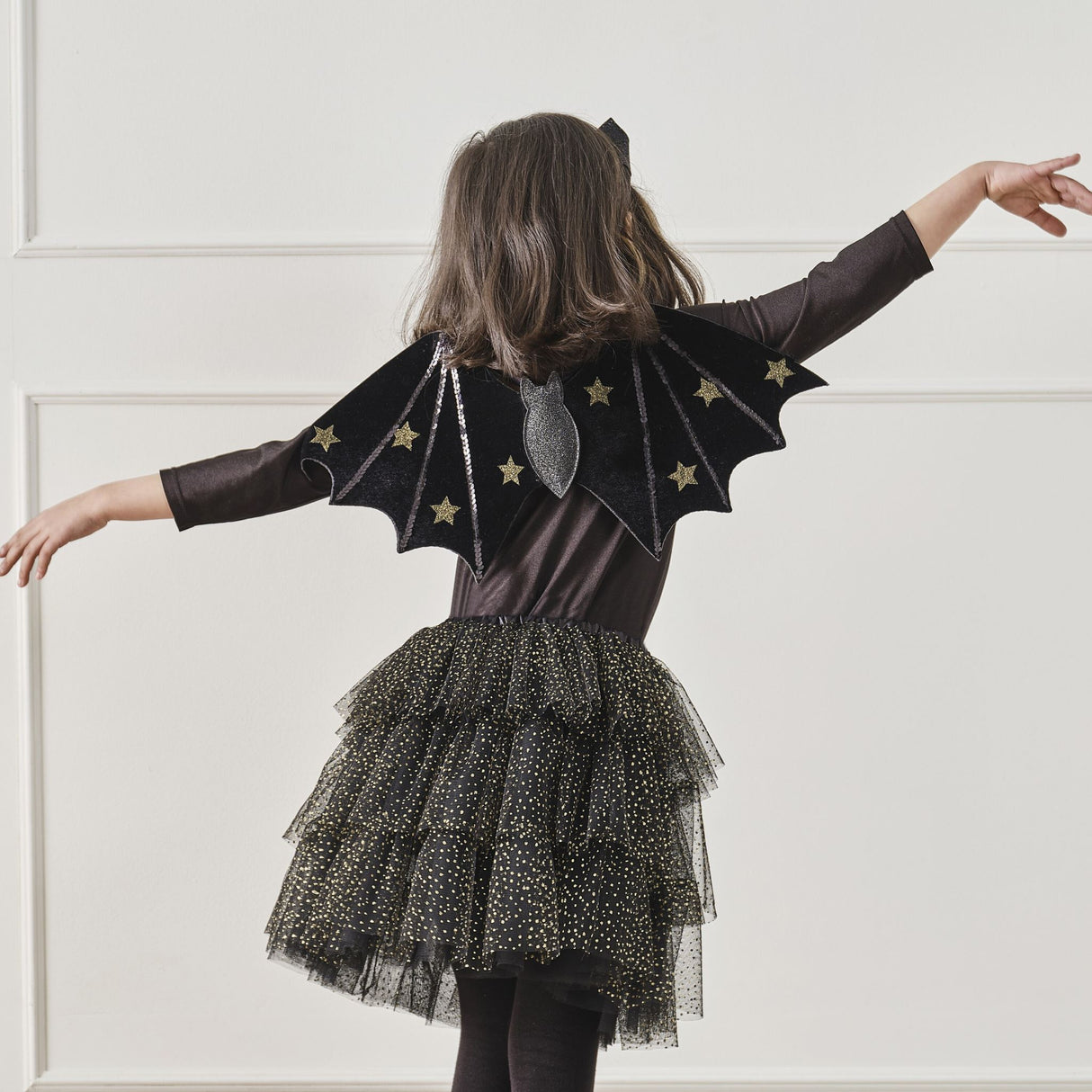 Black and gold sparkle tutu for kids ages 3-5, perfect for imaginative play and Halloween costumes.