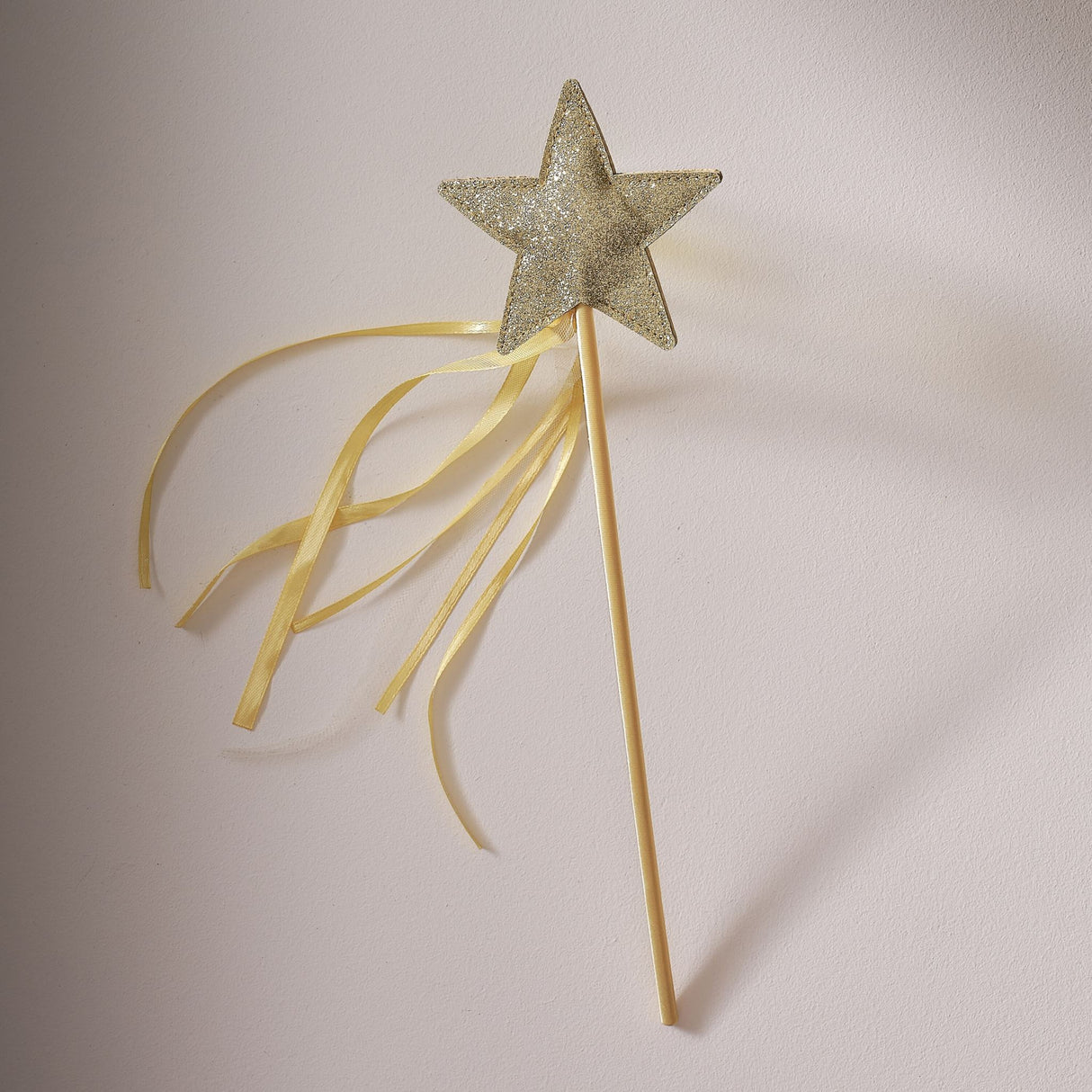 Golden satin fairy wand with a glitter star, ideal for parties and imaginative play, in eco-friendly packaging.