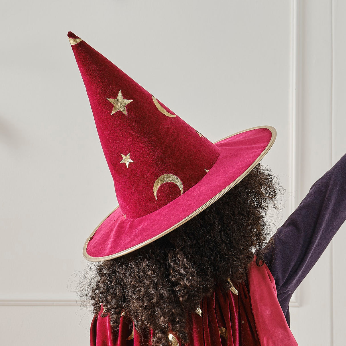 Burgundy velvet magician hat adorned with gold stars and moons, perfect for imaginative play and dressing up.