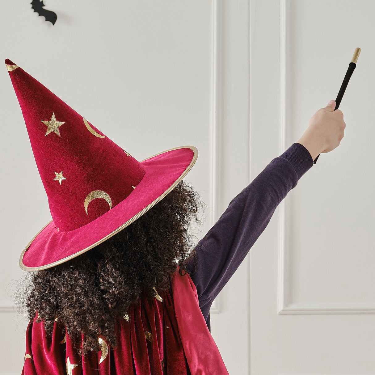 Black and gold magician's wand made of velvet with elegant gold accents, perfect for fancy dress and theatrical performances.