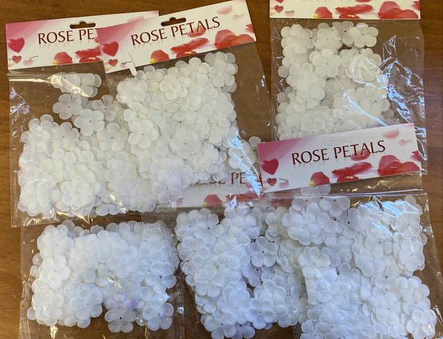 White faux flower petals in 6-pack bundles, perfect for weddings and events, adding elegance without the mess of fresh flowers.