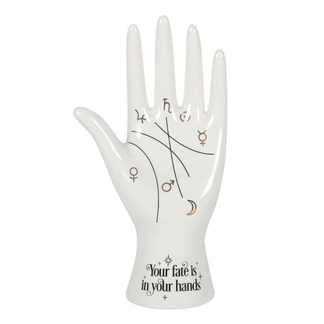 White ceramic palmistry hand ornament with metallic gold astrology symbols and whimsical 'Your fate is in your hands' text.