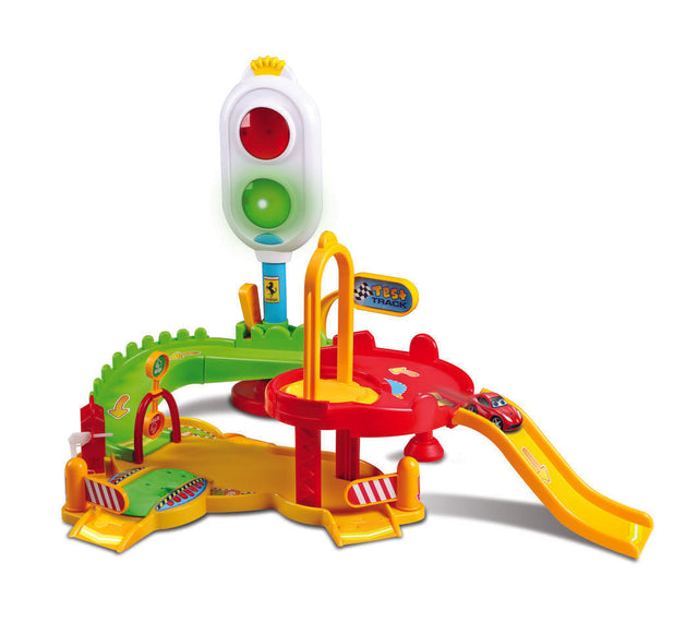 Playset featuring a Ferrari F12 Berlinetta on a vibrant track with lights, sounds, a mechanical lift, and a petrol pump.