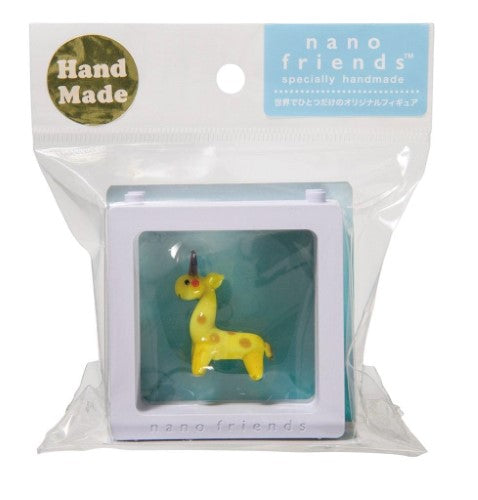 Handmade glass giraffe figurine from the Nano Friends collection, featuring vibrant colors and stackable storage for display.