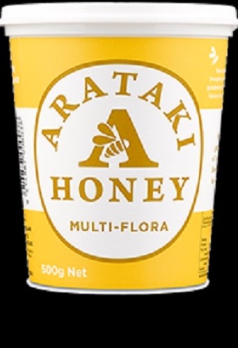 A tub of Arataki 500gm Multi-Flora Honey, rich in flavor and nutrients, ideal for drizzling or cooking.