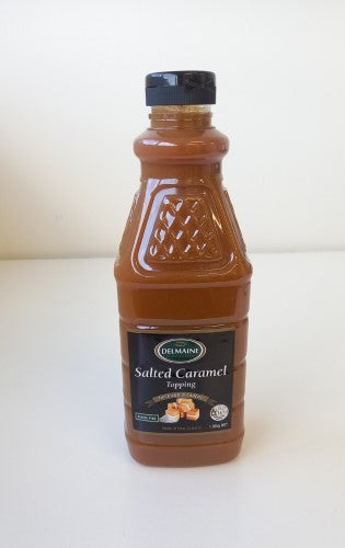 Indulgent 1.3kg bottle of Delmaine salted caramel topping for desserts, perfect for drizzling on ice cream and cakes.