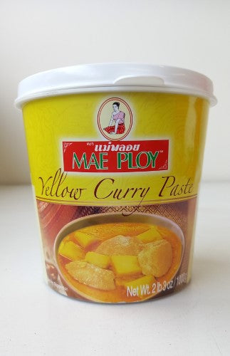 Vibrant yellow curry paste in a 1kg tub, made from quality spices, ideal for enhancing Thai dishes.