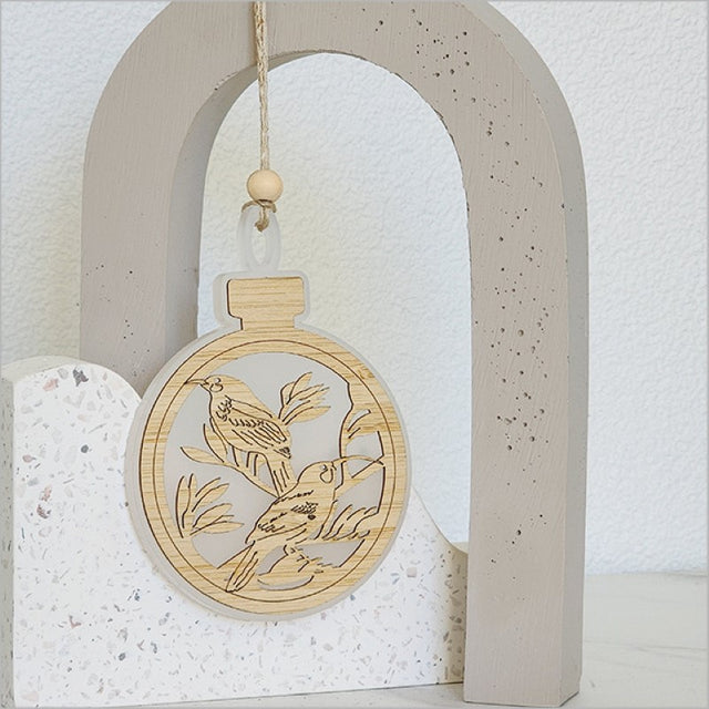 Stunning white satin acrylic bauble ornament with intricate etched designs, perfect for holiday decor and gifting.