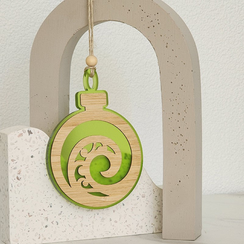 Lime satin acrylic hanging ornament featuring a unique Koru design, perfect for home decor and gifting.