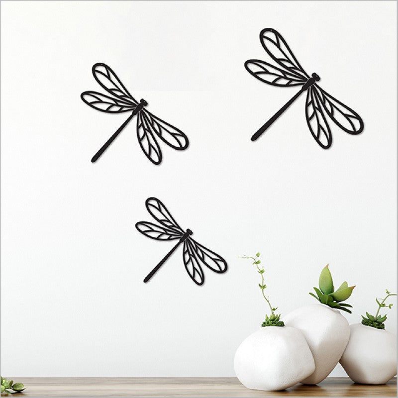 A set of three elegant black acrylic dragonflies in various sizes, perfect for modern wall decor and easy to install.