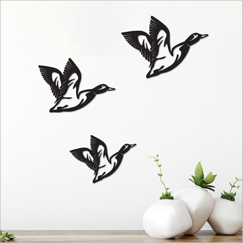 Minimalist acrylic wall art featuring black flying ducks in three sizes, perfect for elegant home decor.