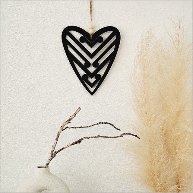 Black acrylic heart wall art featuring five koru designs, symbolizing growth, perfect for enhancing any space.