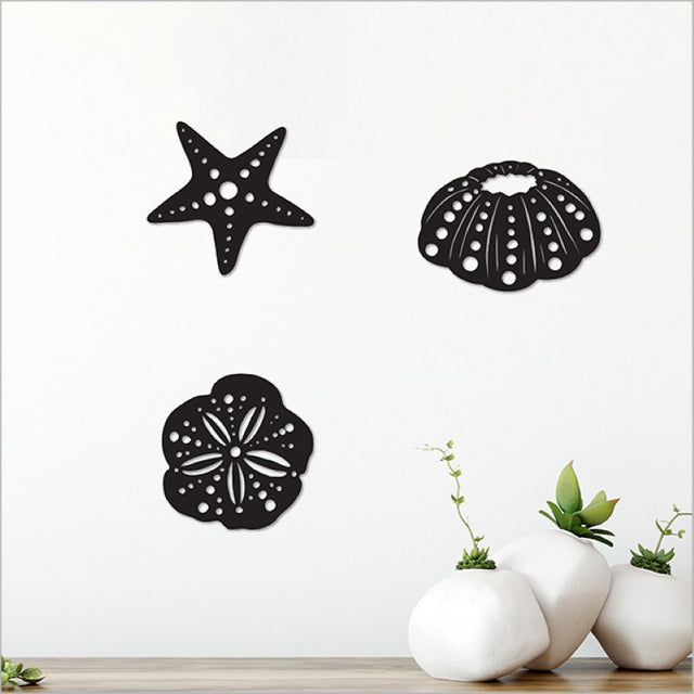 Acrylic wall art set featuring two kina and a starfish, crafted from matt black acrylic for marine-themed decor.