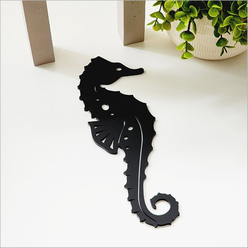 Acrylic wall art featuring a sleek black seahorse design, perfect for enhancing modern and coastal home decor.