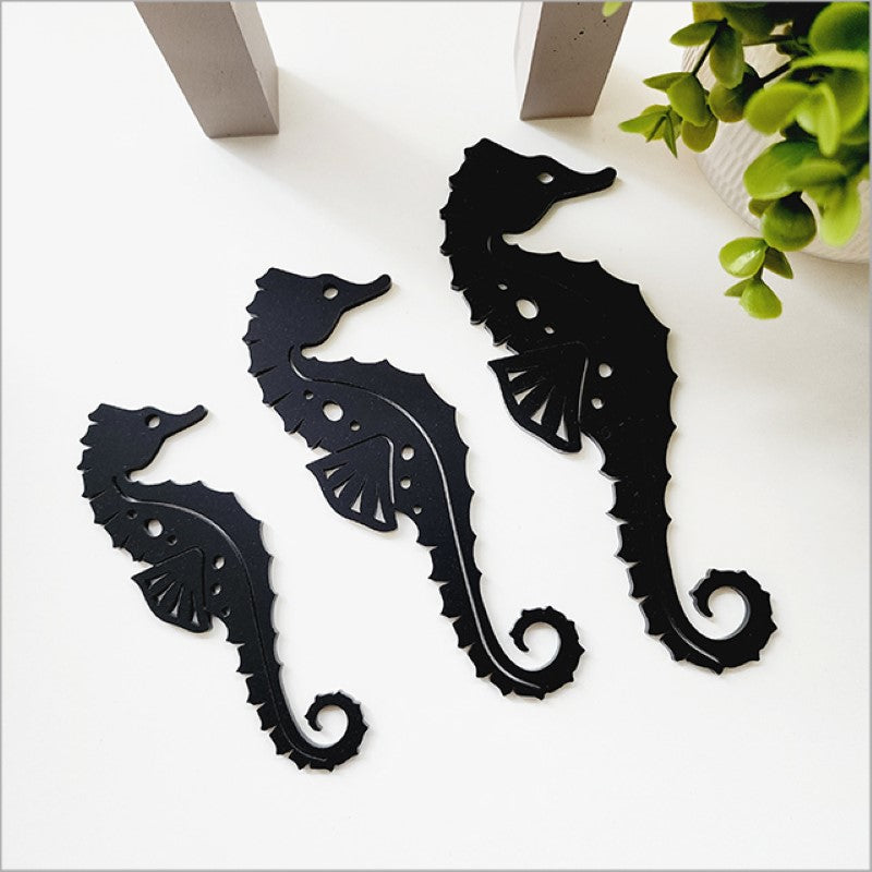 Acrylic wall art set featuring elegant black seahorse shapes in three sizes, perfect for modern nautical decor.