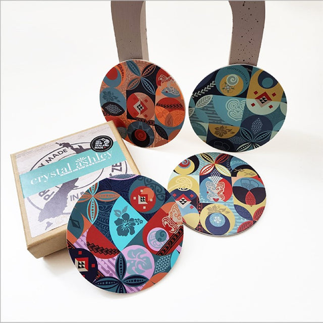 Set of coastal-inspired coasters with vibrant Pacific prints, acrylic top, and cork base for stylish drink protection.