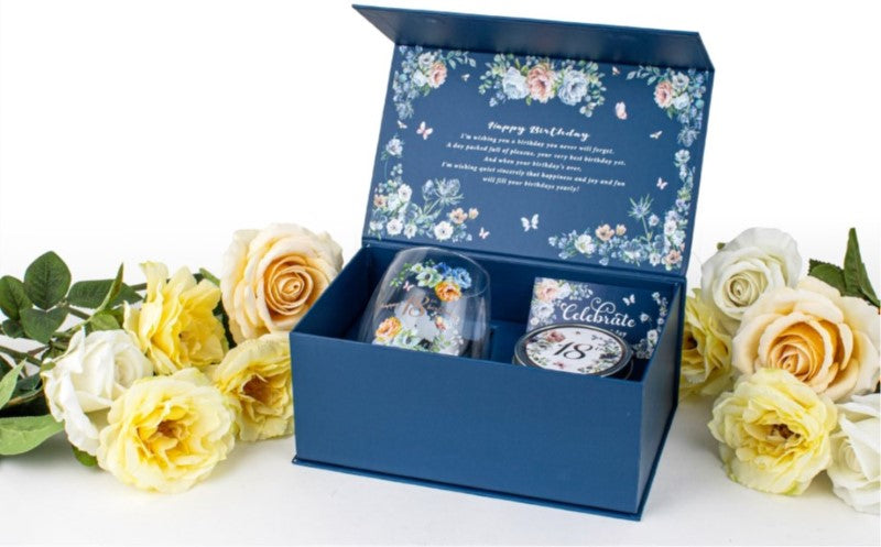 Elegant stemless glass with dancing roses design and vanilla candle, perfect for celebrations and gifts.