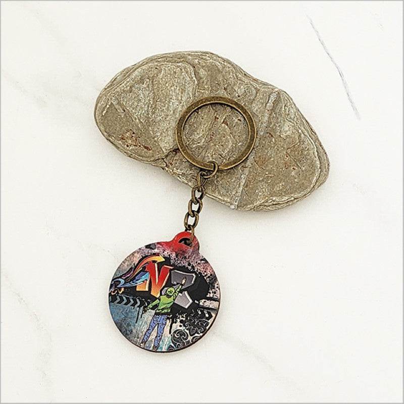 Lightweight printed keychain featuring Kiwiana design, crafted from durable laser-cut pine veneer, 40mm diameter.