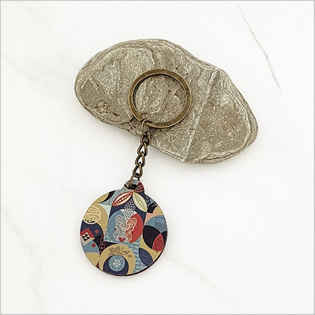 "Pacific Fusion 1 Printed Keychain in lightweight pine veneer, 40mm diameter, showcasing Kiwiana flair for stylish practicality."