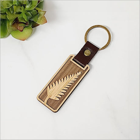 Lightweight bamboo keyring with fern design, capturing Kiwiana charm; eco-friendly and perfect for organizing keys.