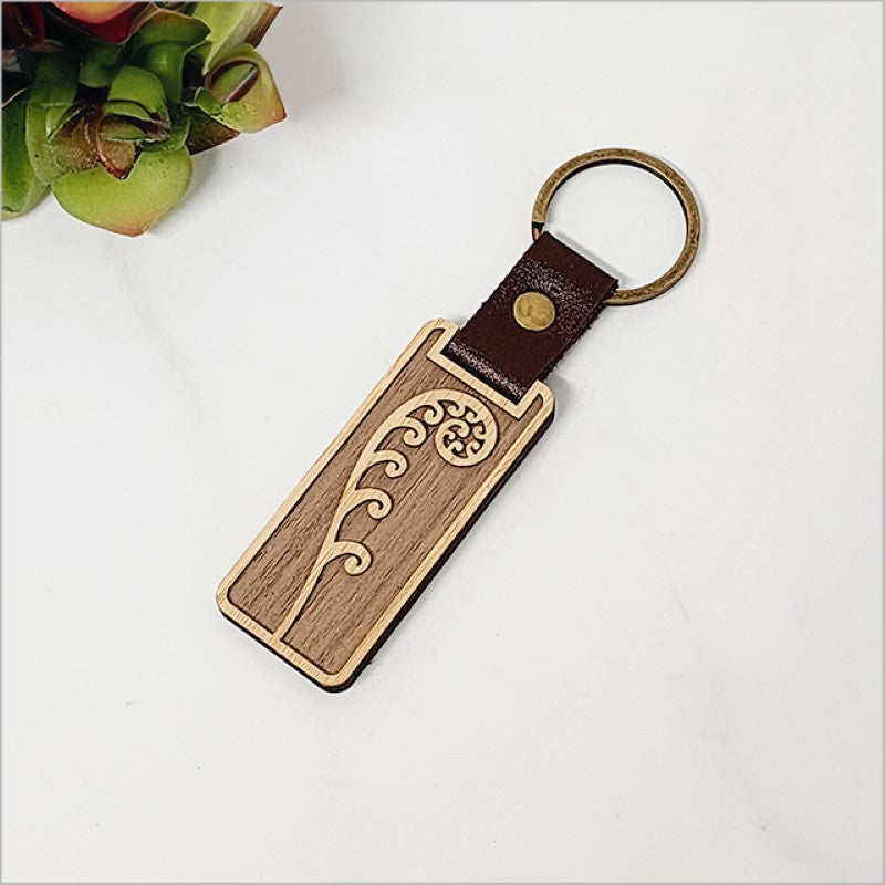Eco-friendly bamboo keyring with delicate frond design, lightweight, durable, and perfect for Kiwiana enthusiasts.