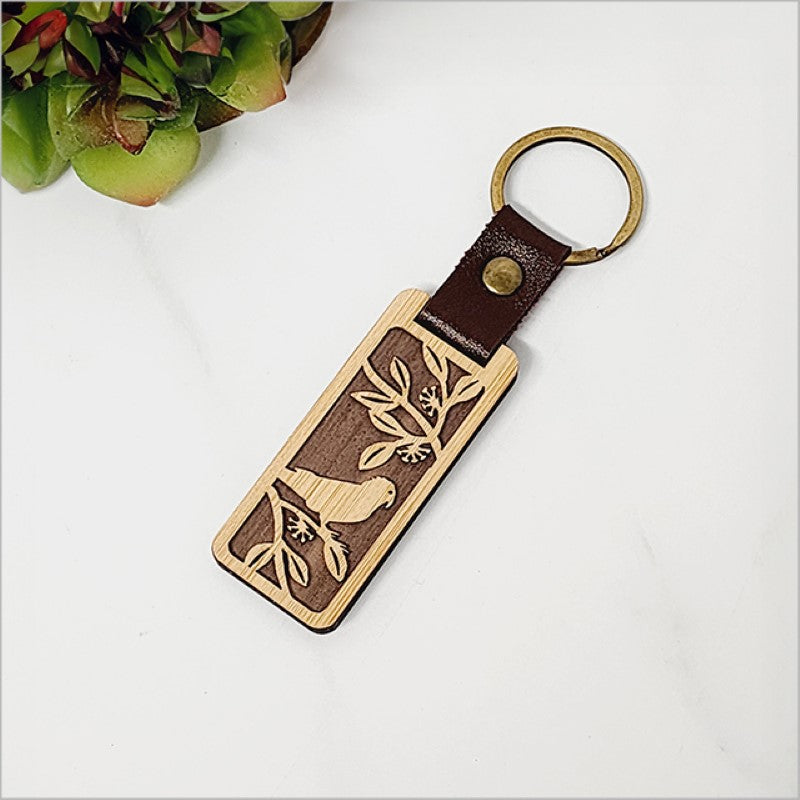 Eco-friendly bamboo keyring with Kiwiana charm, laser-cut design, perfect for travel or unique gifts.